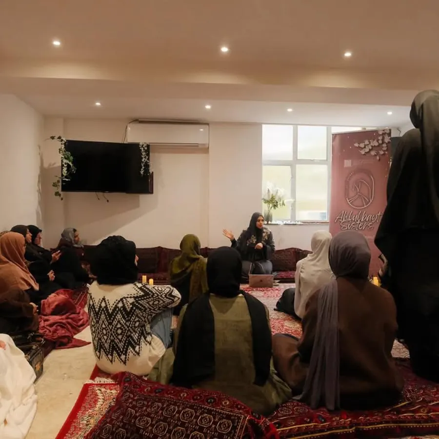 Sisters gathered for a session beneath the Ahlulbayt Sisters banner
