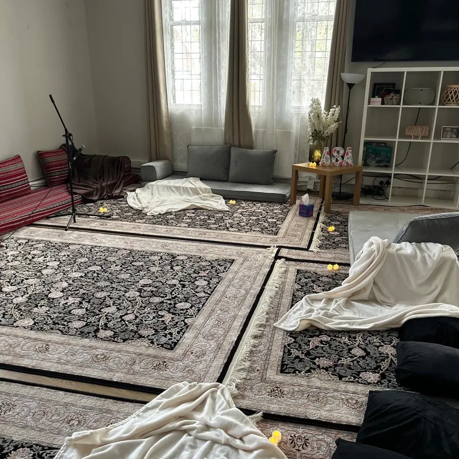 The room laid out with rugs and candles before a session
